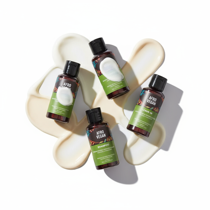 Inoar Afro Vegan hair care set with shampoo, leave-in, and conditioner bottles arranged on cream product smears