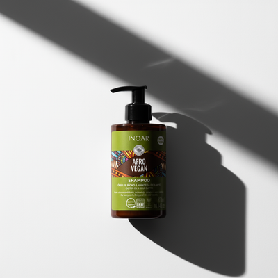 Inoar afro vegan shampoo for curls in brown bottle with pump and colorful label on white background