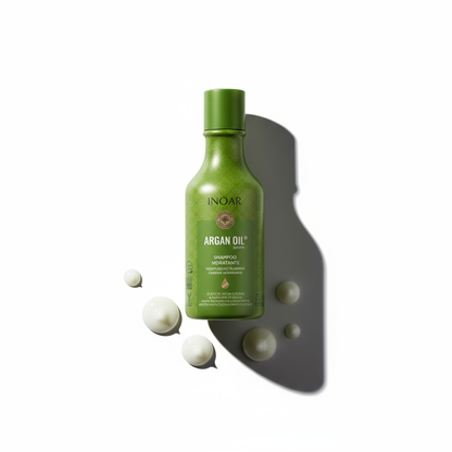 Inoar argan moisturizing shampoo green bottle with argan oil cream droplets on white background