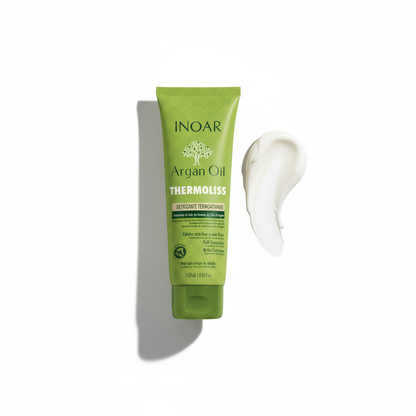 Inoar Argan Oil Thermoliss Anti-Frizz Balm green tube with white cream swatch beside it