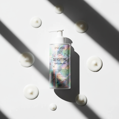 Inoar gentle hair cleansing lotion Sensitine bottle with lotion drops on white background