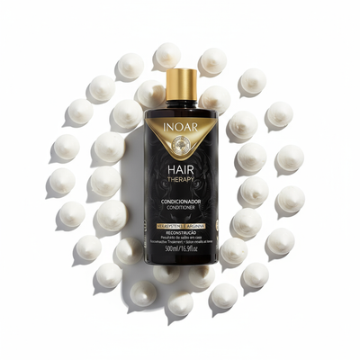 Inoar Hair Therapy Conditioner bottle surrounded by white cream dollops on white background