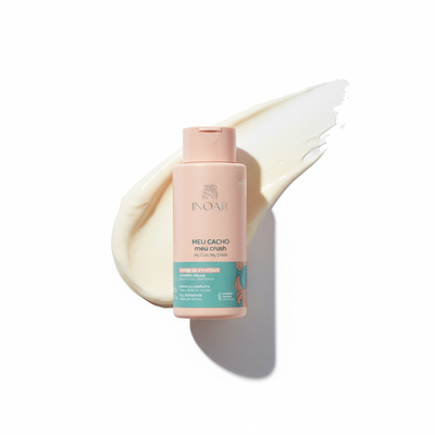 Inoar My Curl My Crush Combing Cream leave in cream bottle with cream smear background