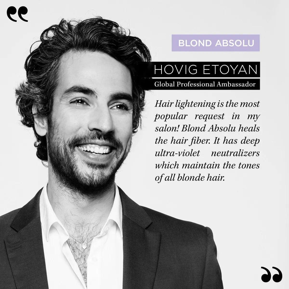 Smiling man with dark curly hair using Kerastase Blond Absolu Bain Ultra-Violet Shampoo