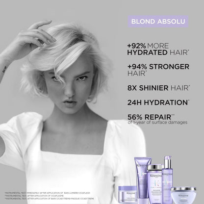 Black and white image of woman with short blonde hair using Kerastase Blond Absolu Bain Shampoo