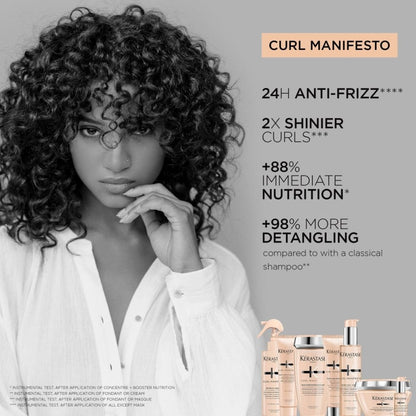 A woman with voluminous curly hair posing for Kerastase Curl Manifesto hair mask ad