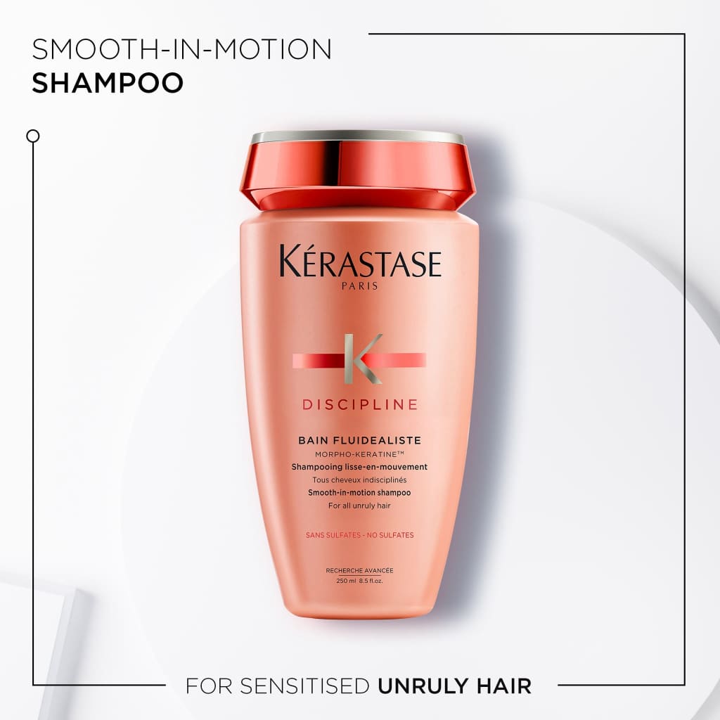 Peach-colored Kérastase shampoo bottle for disciplining unruly, sensitized hair, sulphate free