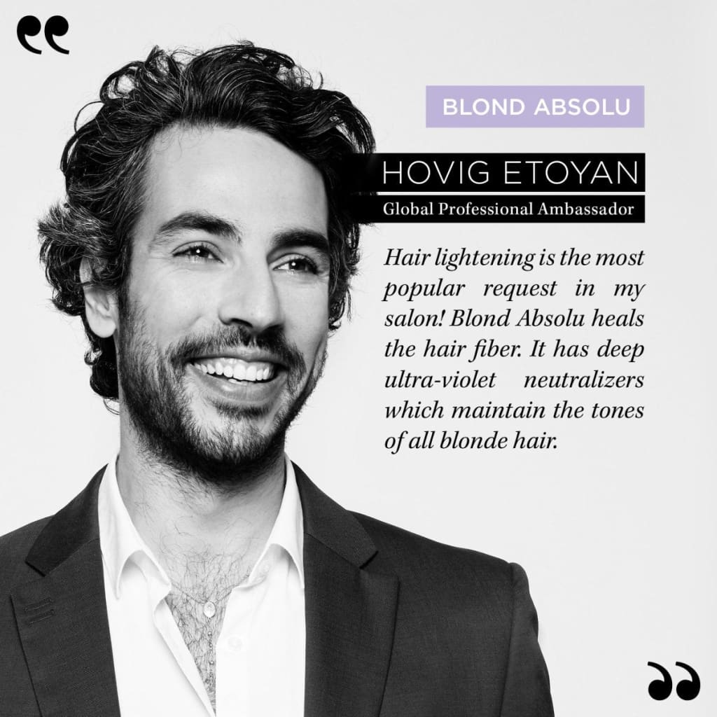 Portrait of a smiling man with dark curly hair promoting Kérastase Blond Absolu Shampoo 250ml