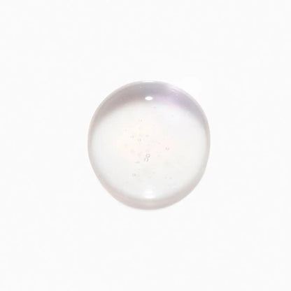 Translucent spherical object with Kérastase Blond Absolu Shampoo 250ml in background