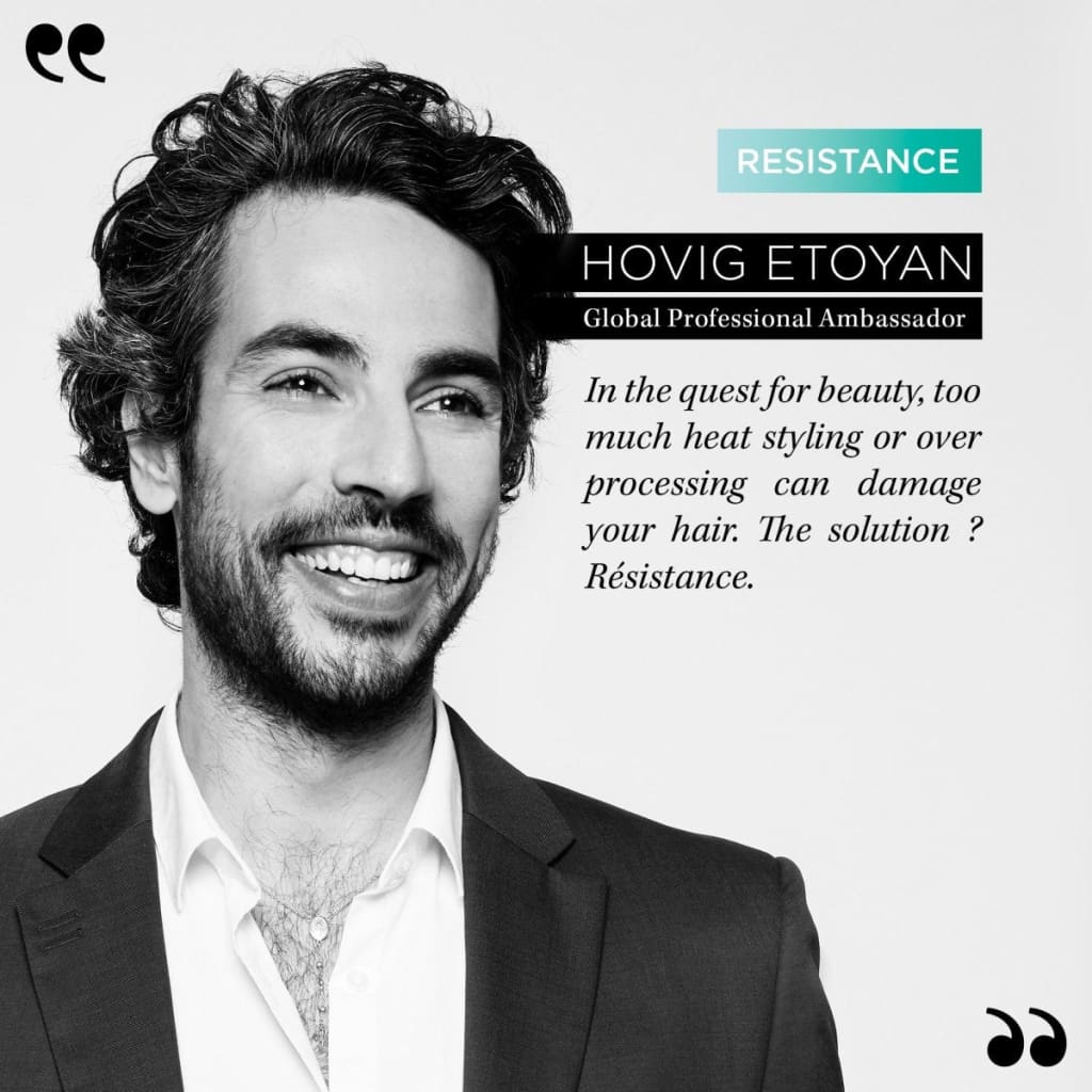 Portrait of a smiling man with curly hair and beard using Kerastase hair mask 200ml