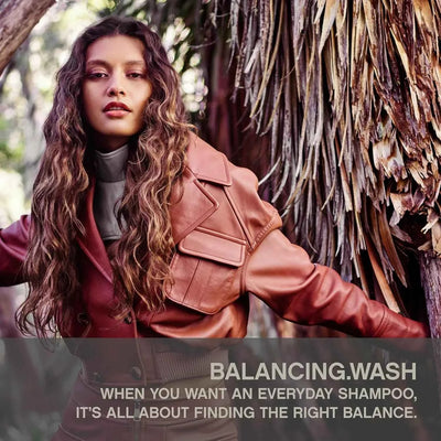Kevin Murphy Balancing.Wash: Sulphate-Free Shampoo for Healthy, Curly Hair. Model with shiny curls promotes this balancing wash.