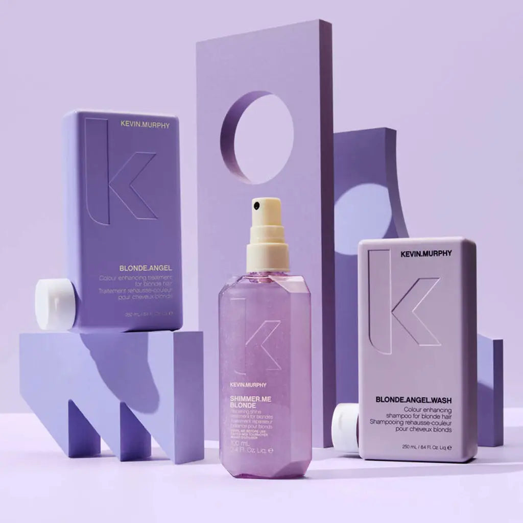 Purple spray bottle of hair product surrounded by matching packaging and geometric shapes.