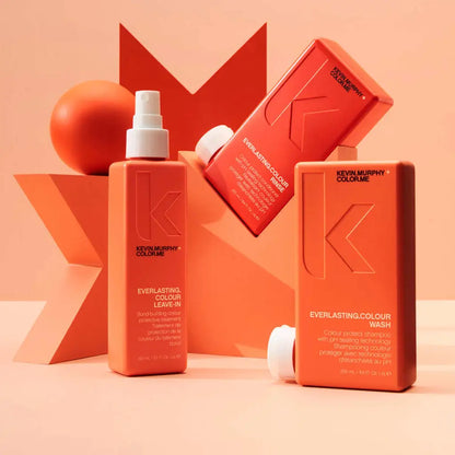 Collection of orange-colored hair care products from the Kevin Murphy brand.