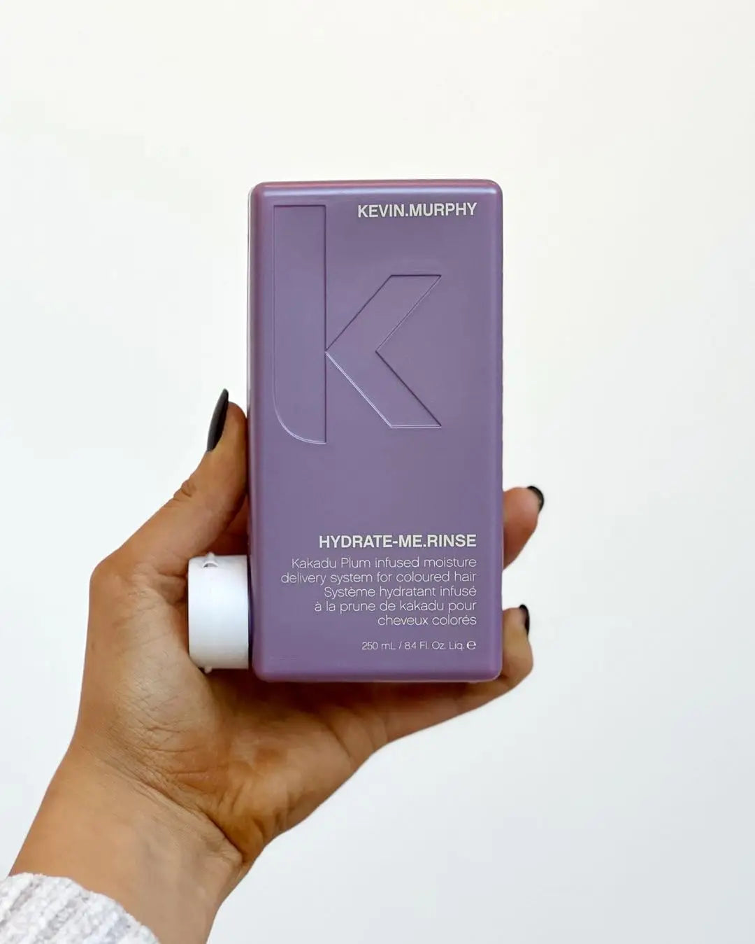 Purple bottle of Kevin Murphy Hydrate-Me Rinse hair product, for essential moisture