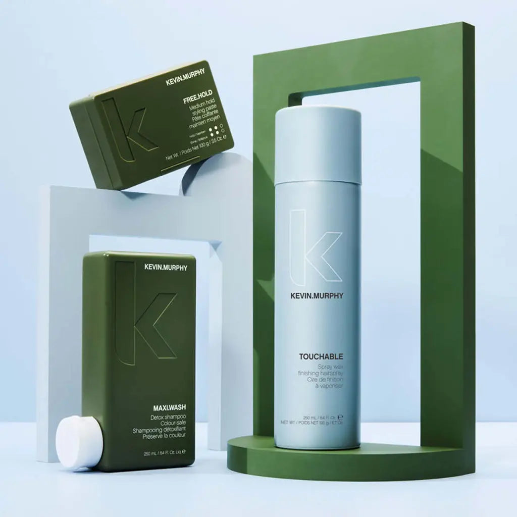 Cylindrical silver hair product container displayed with green packaging boxes.