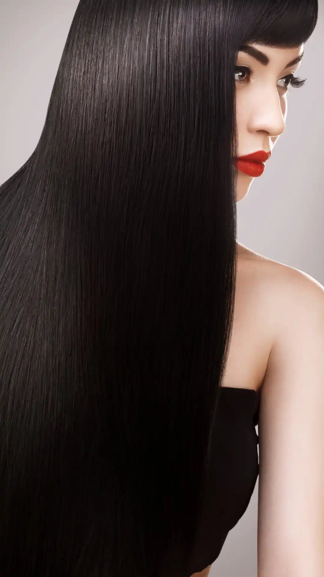 Long, straight, glossy black hair cascading down a woman’s profile.