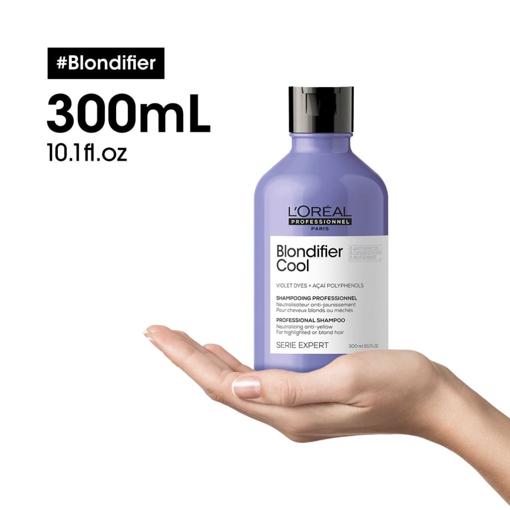 Purple bottle of L’Oreal Blondifier Cool shampoo held in hand for l’oréal professionnel