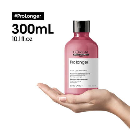 Pink L’Oreal Pro Longer Shampoo 300ml held in an open palm - l’oréal professionnel