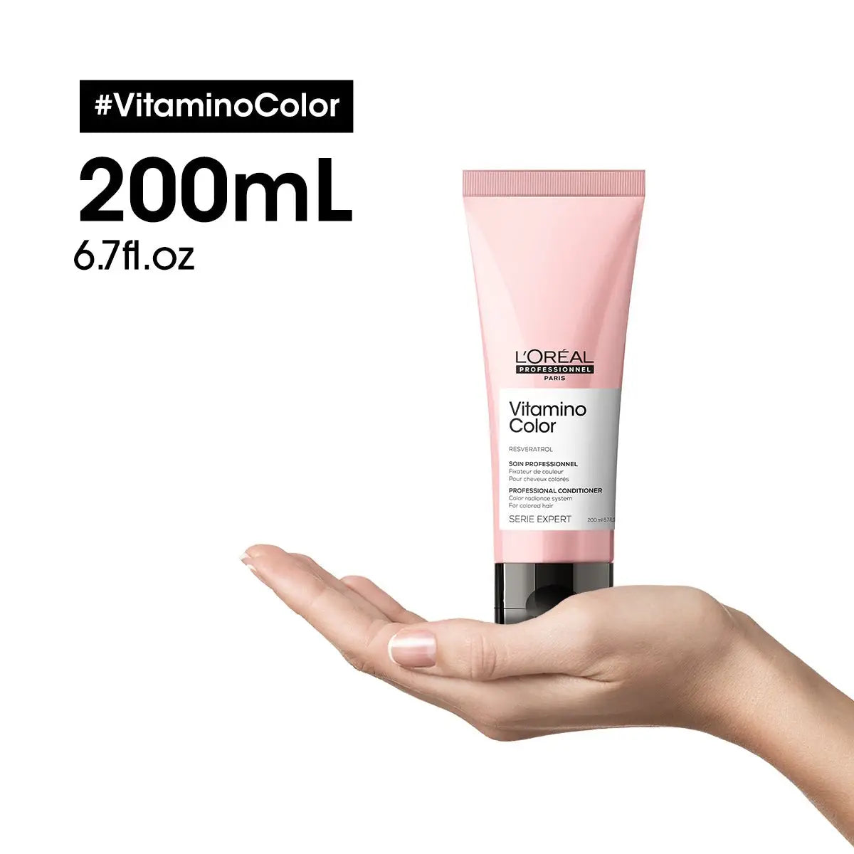 Hand holding a pink tube of L’Oréal Professionnel Vitamino Color Conditioner 150ml