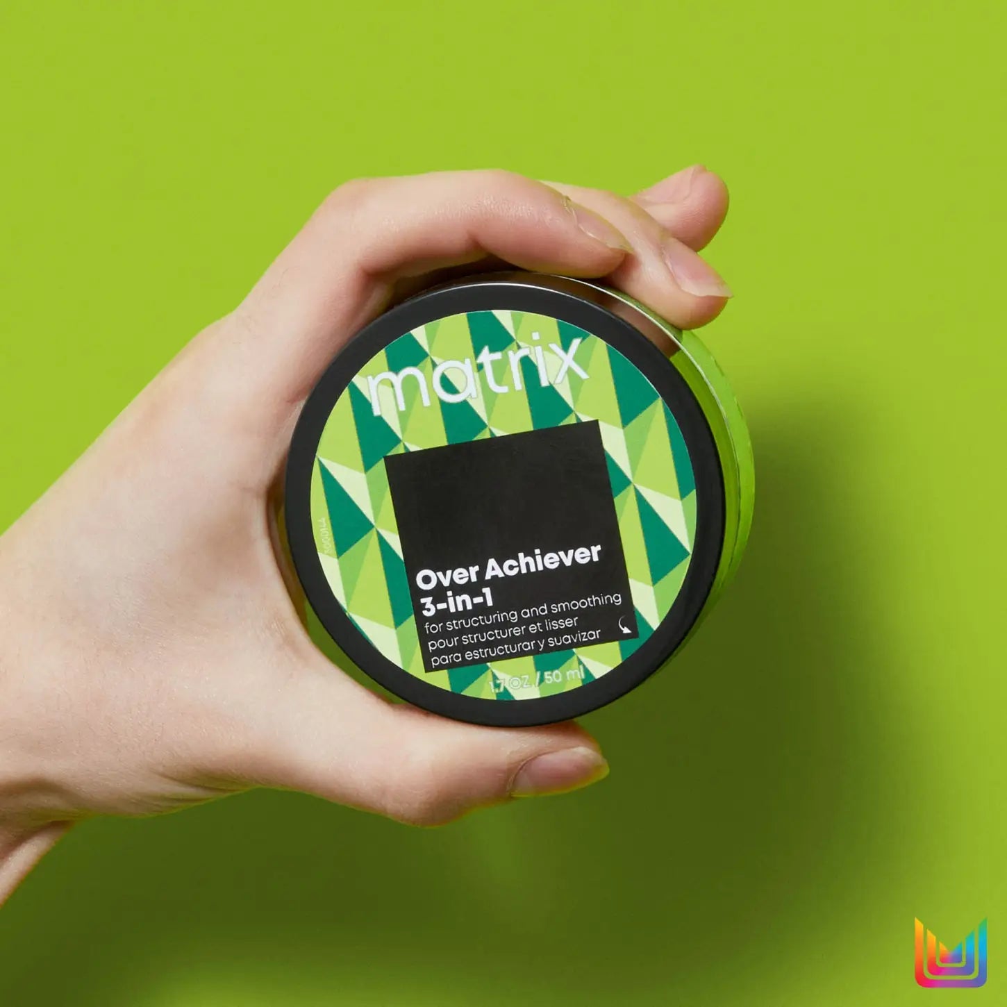 Matrix Style Link Over Achiever - 50ml: The innovative hair cream held against a green background