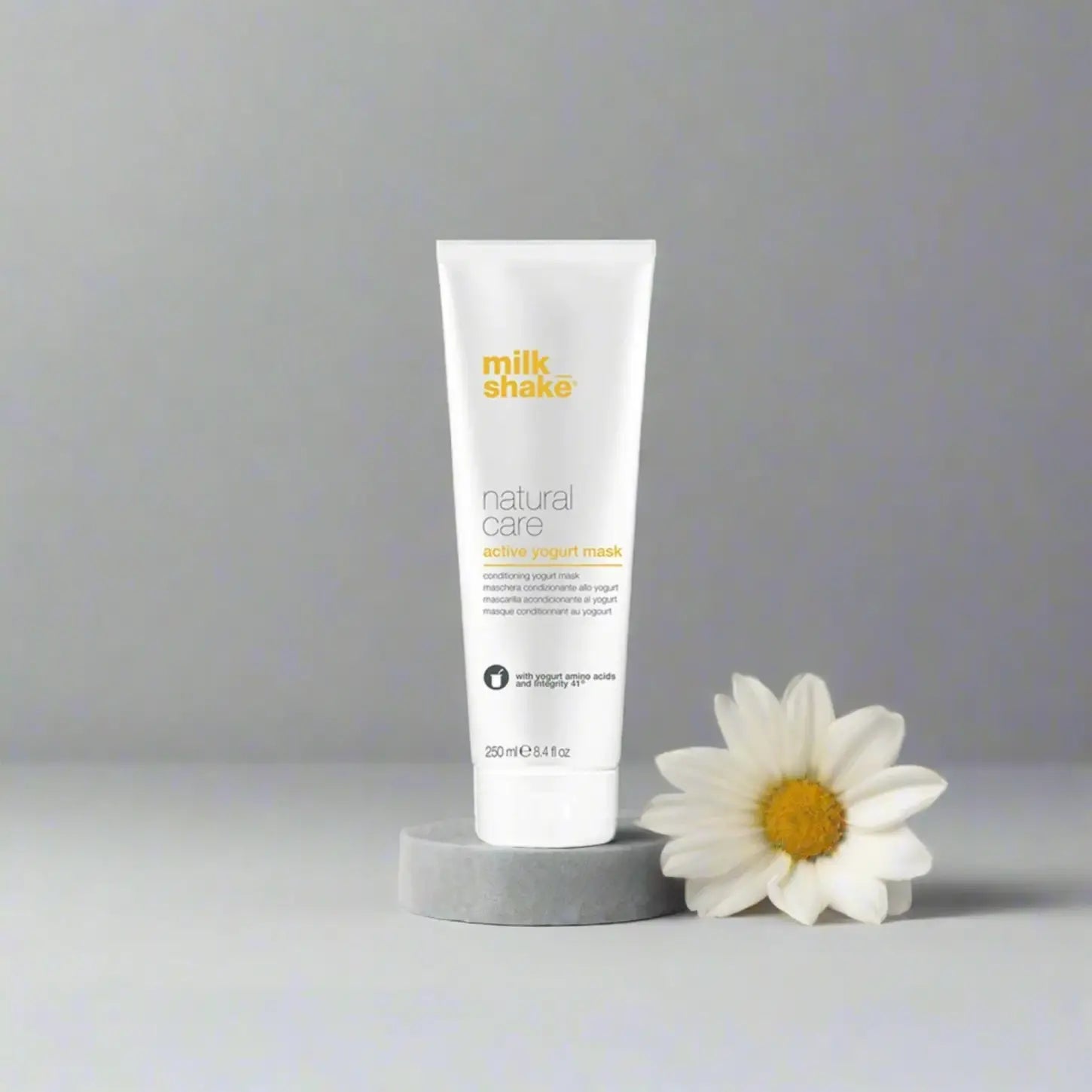 Milkshake Active Yogurt Mask natural care treatment tube with daisy flower on gray background