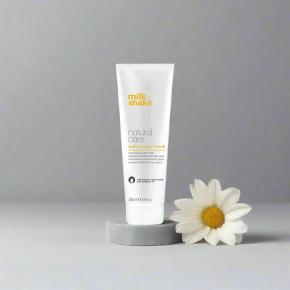 Milkshake Active Yogurt Mask natural care treatment tube with daisy flower on gray background