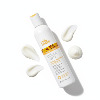 Milkshake color-treated hair conditioner bottle with creamy texture swatches on white background