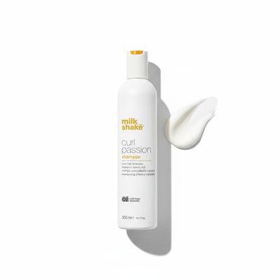 Milkshake Curl Passion Shampoo bottle with creamy product swatch on white background
