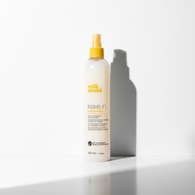Milkshake leave in conditioner 350ml bottle with yellow spray cap on white background