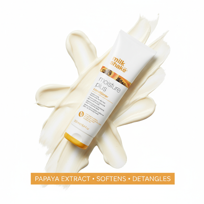 Milkshake Moisture Plus Conditioner tube with papaya extract on creamy conditioner background