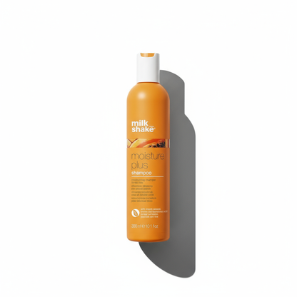 Milkshake Moisture Plus Shampoo in orange bottle with white cap for hydrated hair care