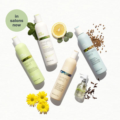 Milkshake Normalizing Blend Shampoo bottle with natural ingredients like seeds and lemon around