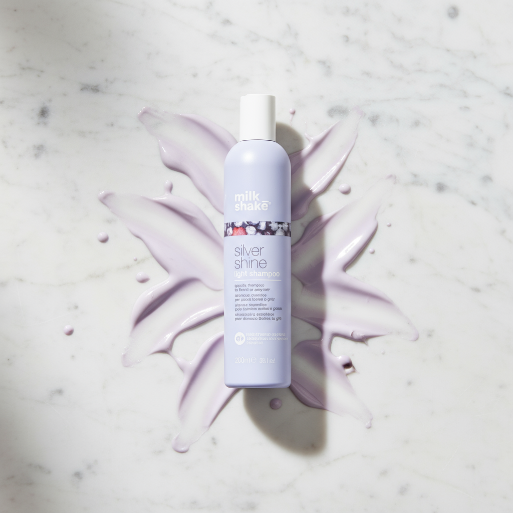 Milkshake Silver Shine light Shampoo bottle on marble surface with purple shampoo smear background