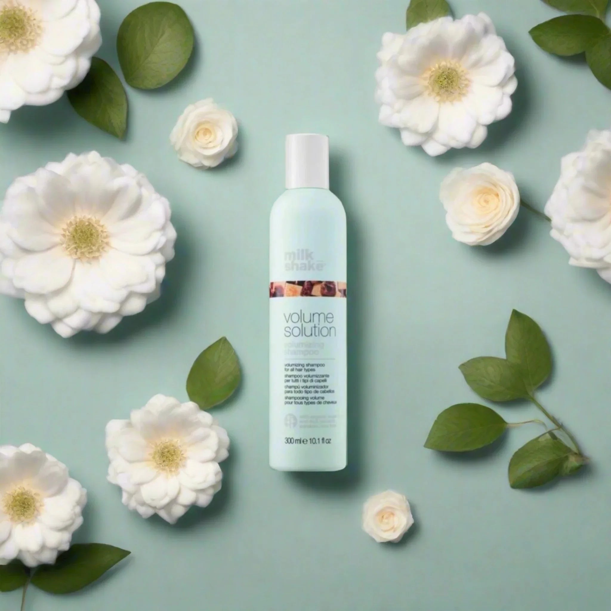 Milkshake Volume Solution Shampoo 300ml, surrounded by white flowers and green leaves