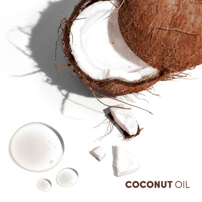 Cracked open coconut with oil droplets, featured in Mizani Coconut Souffle Hairdress Conditioner 240ml