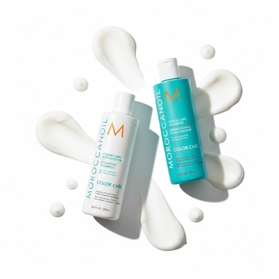 Moroccanoil Color Care bundle with shampoo and treatment bottles surrounded by white cream swatches