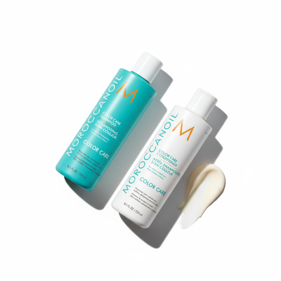 Moroccanoil Color Care bundle with turquoise shampoo and white conditioner bottles alongside cream texture