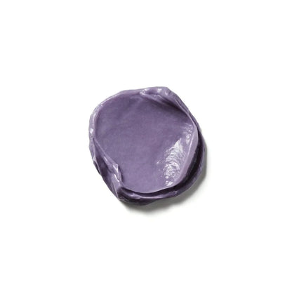 Blob of purple Moroccanoil Color Deposit Mask Platinum cream with shiny surface