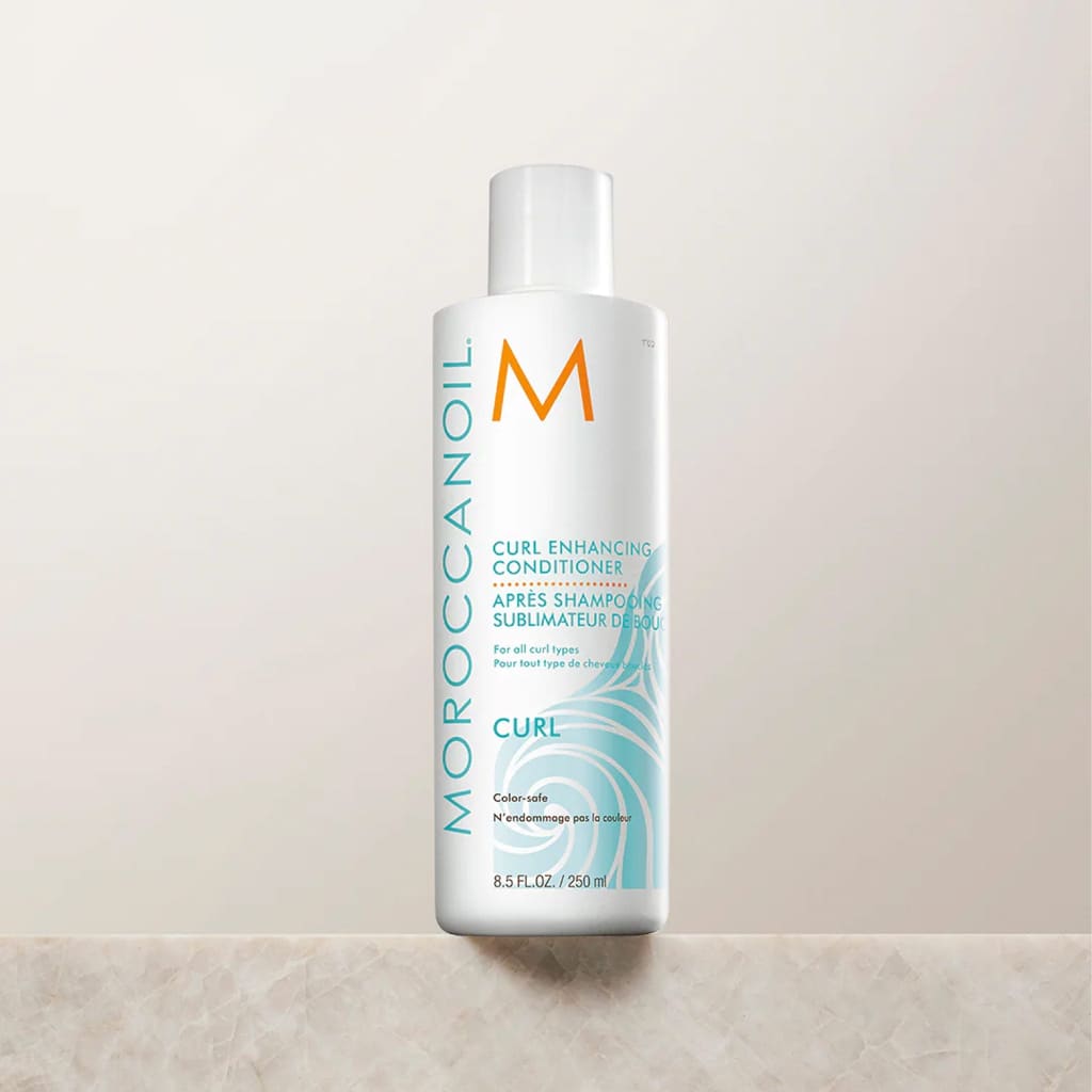 White bottle of Moroccanoil Curl Enhancing Shampoo for frizz-free curls