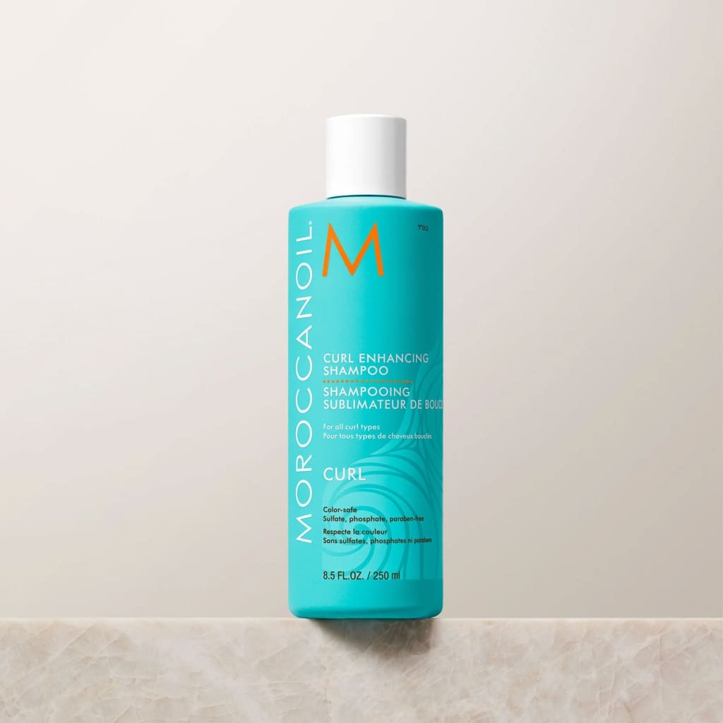 Teal bottle of Moroccanoil Curl Enhancing Shampoo 250ml for defined curls