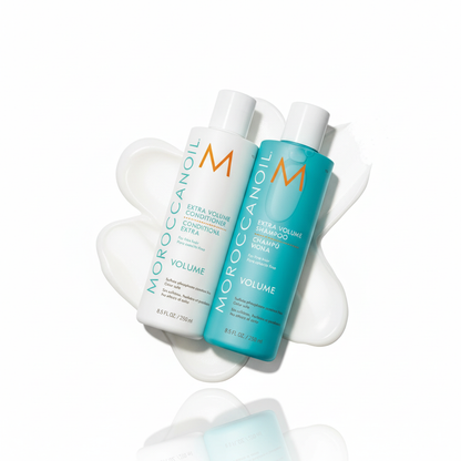 Moroccanoil Extra Volume Bundle with shampoo and conditioner bottles on white cream background