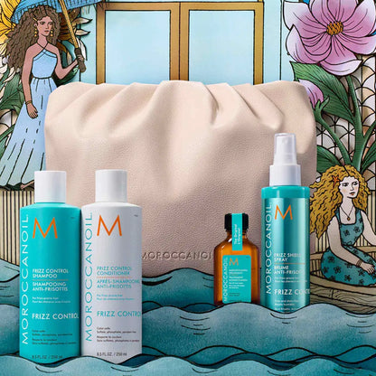 Collection of Moroccanoil hair care products displayed with a beige cosmetic bag.