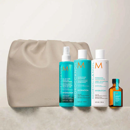 Collection of Moroccanoil hair care products with a beige cosmetic bag.