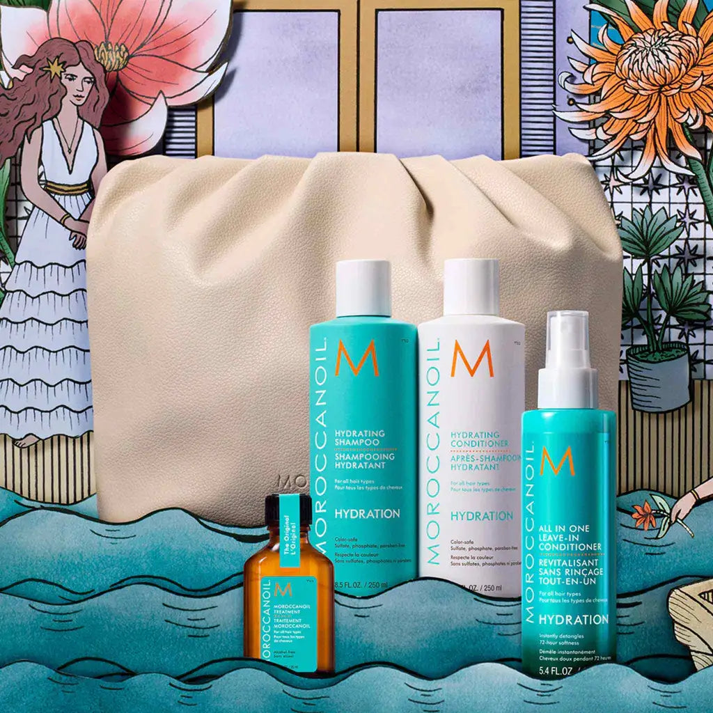 Collection of Moroccanoil hair care products displayed with a beige cosmetic bag.