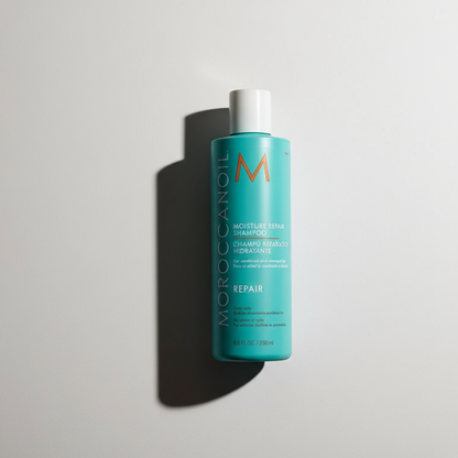 Moroccanoil Moisture Repair Shampoo in turquoise bottle with white cap for hair repair
