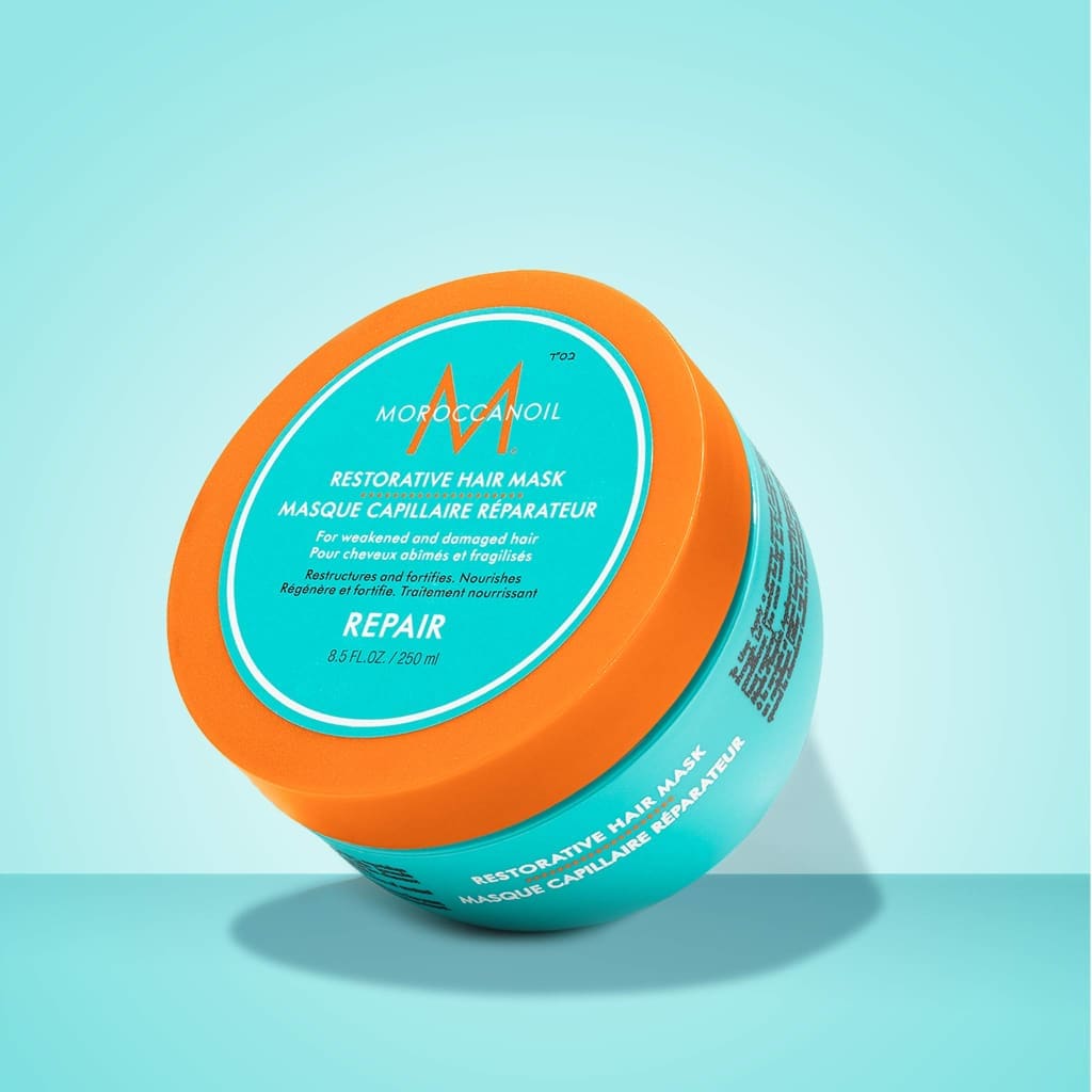 Circular container of Moroccanoil Restorative Mask 250ml for damaged hair in orange and turquoise