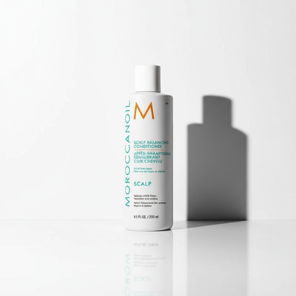 Moroccanoil scalp balancing conditioner white bottle with teal and orange branding on white surface