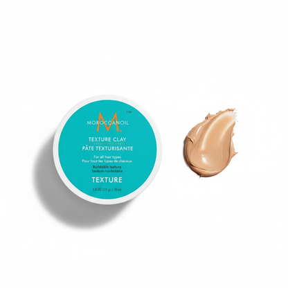 Moroccanoil Texture Clay styling aid container with a swatch of textured clay for hair