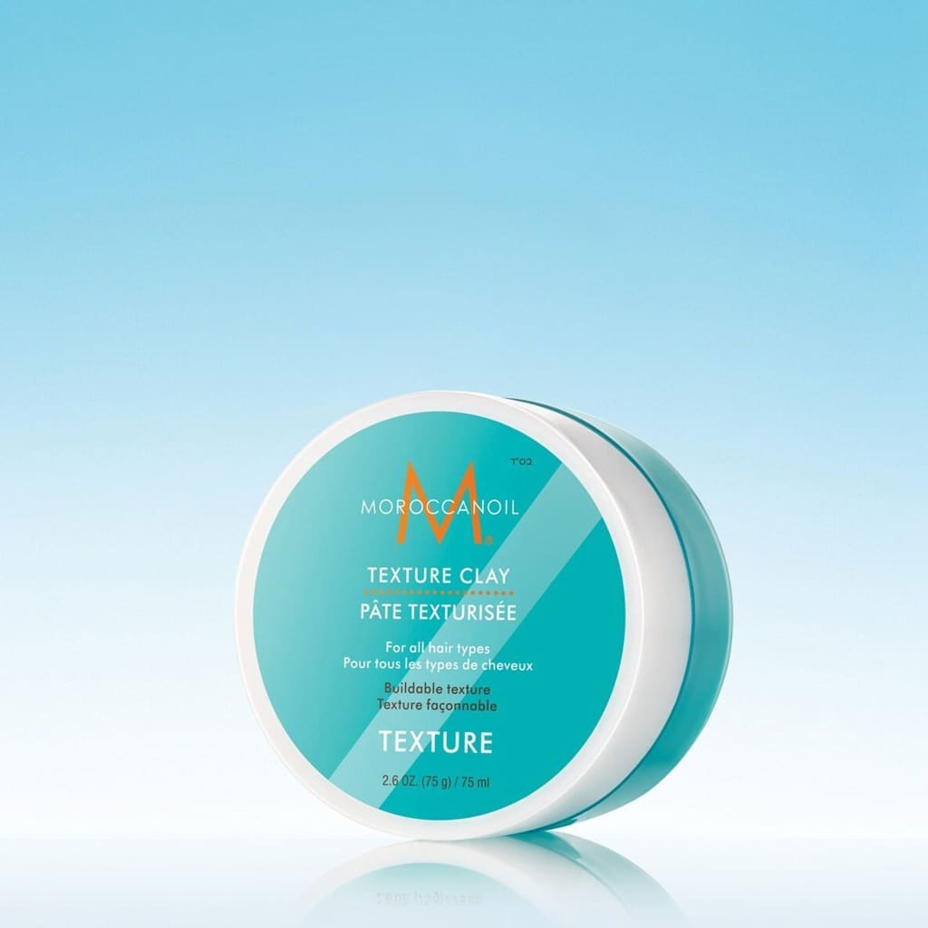 Teal and white container of Moroccanoil Texture Hair Styling Clay 75ml, strong hold, matte finish