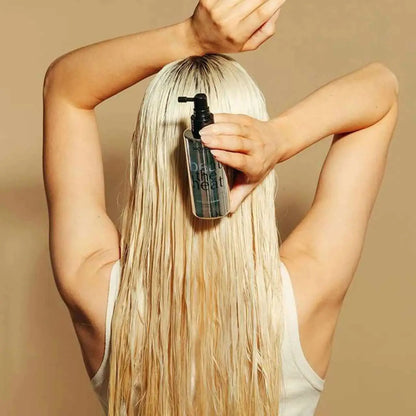 Long platinum blonde hair being sprayed with Moyoko Beat the Heat Protector Spray in Cape Town